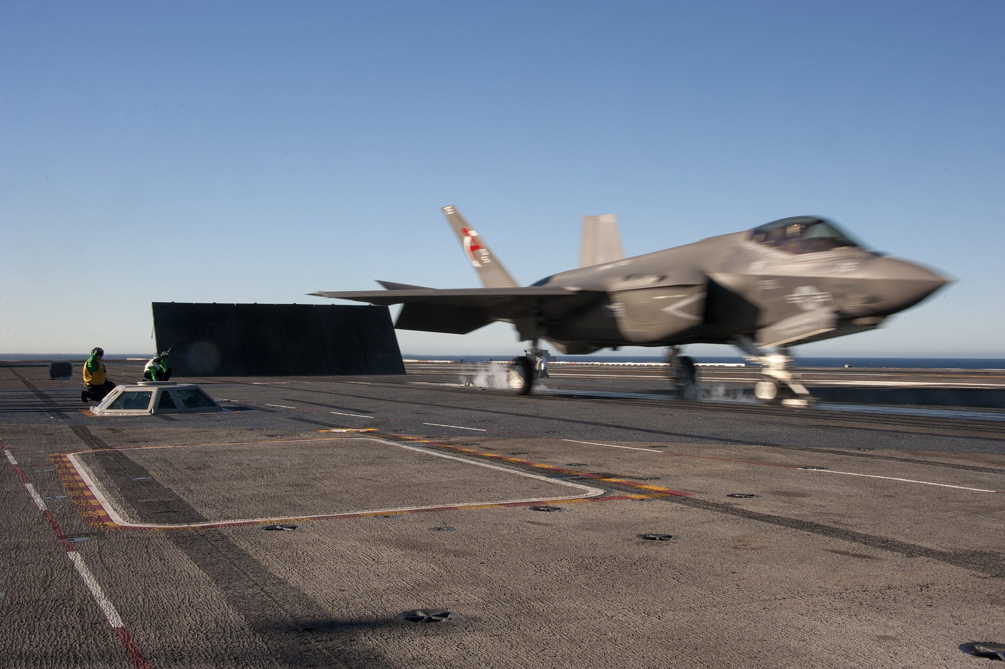 A fighter jet sitting on top of an airport runway.